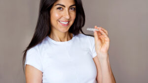 Woman Holding Clear Aligner