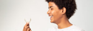 boy teenager afro smiling with dental aligners